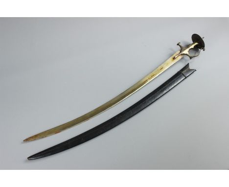 An Indian Talwar, having single edge curved blade, with brass grip with knuckle bow, steel disc pommel with a short protrudin