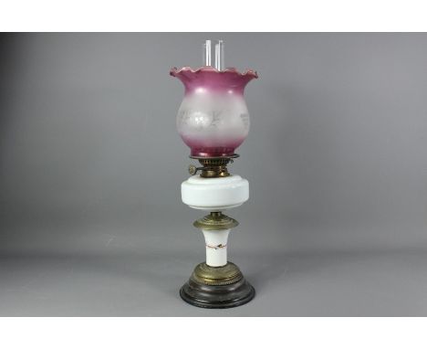 A Victorian oil lamp, with white glass reservoir and lilac etched fluted shade, approx 59 cms.&nbsp;