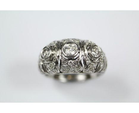 Antique platinum and diamond dress ring, the ring set with 1 x 18 pts and 2 x 16pts of dias, on a fretwork floral mount and f