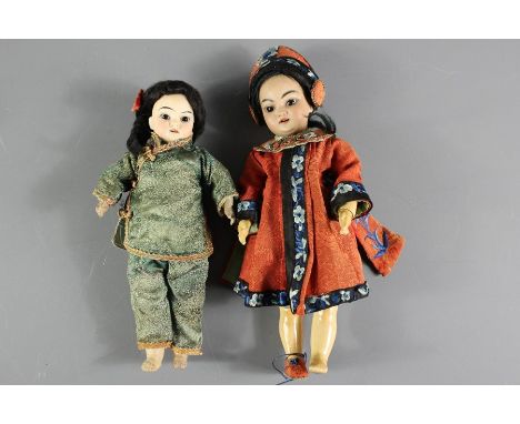 Two Bisque-headed Asian Dolls, the first doll having a bisque head with painted eyes, an open mouth revealing teeth, the doll