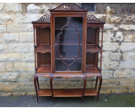 Edwardian mahogany display cabinet; the cabinet having three shelves, glazed doors, two shelves to either side with decorativ