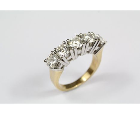 An 18ct yellow and white stone ring. The ring set with five brilliant-cut white stones, approx 6.96 gms, size L+.