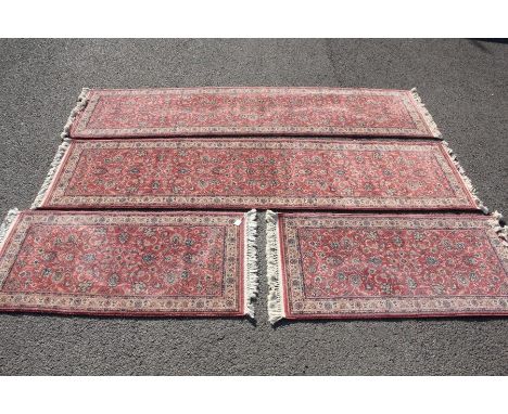 Four 20th Century woollen carpets. The first being a small woollen rug approx 68 x 140 cms with a pink and turquoise foliate 