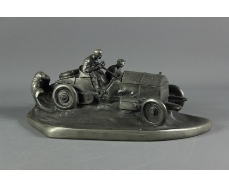 Early 20th century pewter-effect inkwell; the inkwell in the form of a racing car with two men, the bonnet opens to reveal a 