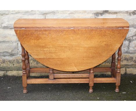 Light Oak Drop Leaf Table, approx 122 x 130 x&nbsp; 76 cms, the table having turned legs, straight stretchers bun feet, toget