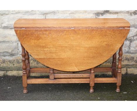 Light Oak Drop Leaf Table, approx 122 x 130 x&nbsp; 76 cms, the table having turned legs, straight stretchers bun feet, toget