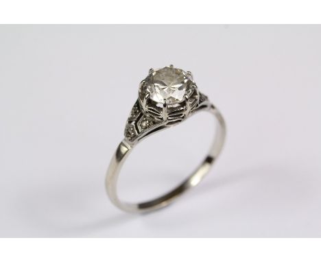 Antique 18ct white gold diamond ring. The center old-cut diamond approx 1.25ct, set with six 1pt rose-cut diamonds to shoulde
