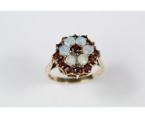 9ct yellow gold, garnet and opal ring, size Q, approx 4.1 gms. (af)Condition for this Lot - Sale 18/12/19one of the opals has