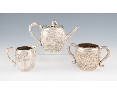 A late 19th / early 20th Century Chinese white metal three piece tea set, comprising of a teapot, milk jug and sugar bowl, al