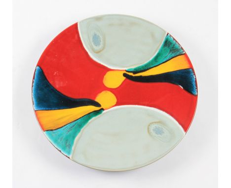 A late 20th Century Poole pottery charger with abstract multi coloured design.