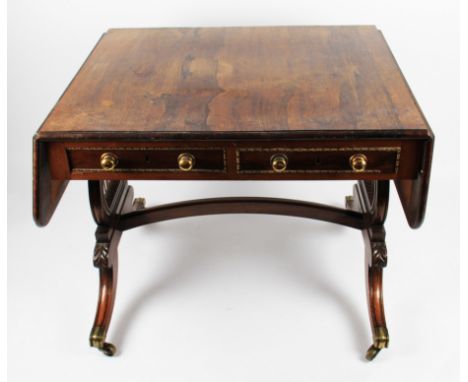 A 19th Century Regency rosewood drop leaf sofa table with two drawers and two false drawers on lyre shaped supports with dome