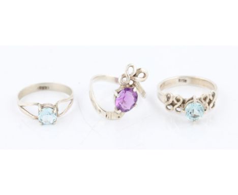 A lot to include two aquamarine set rings, both set in white metal, one stamped 925, together with an amethyst set ring, set 