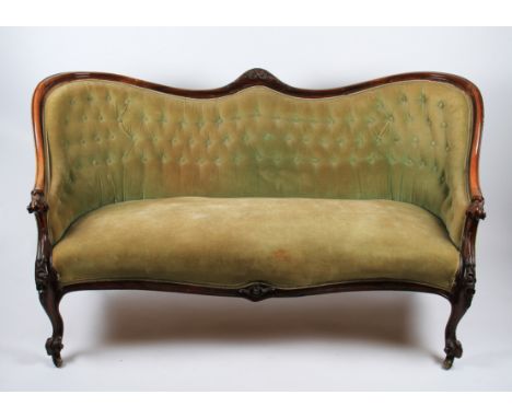 A 19th Century Victorian rosewood framed chaise lounge with button backed green upholstery.