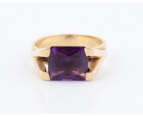 An amethyst dress ring, set with a rectangular cut amethyst, measuring approx. 10x9mm, within raised split shoulders, set in 