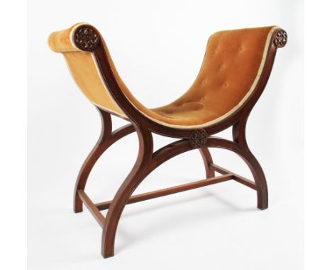 A 19th Century Victorian mahogany X-frame stool with carved rose head roundel design with tan coloured button backed upholste
