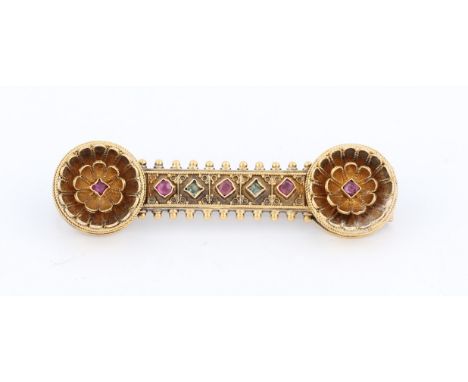 A Victorian Gothic revival ruby and emerald bar brooch, set in unmarked yellow metal, length approx. 4.5cm.