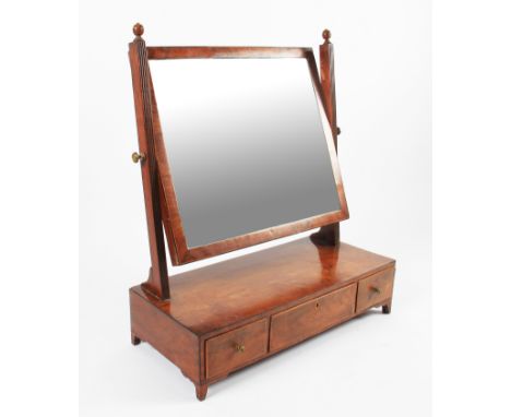 A 19th Century Georgian mahogany swing mirror with central drawer with two smaller drawers with square swing supports, all on