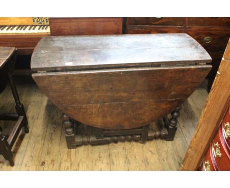 An 18th Century oak gate leg table on bobbin turned legs