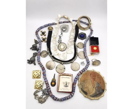 A collection of jewellery, including a string of 19th century venetian chevron drawn cane glass beads, a mother of pearl leaf