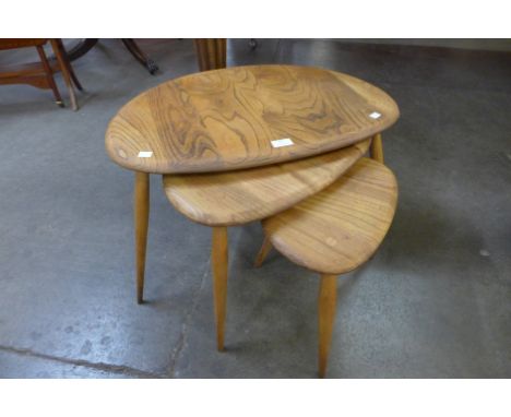 An Ercol elm and beech pebble shaped nest of tables 