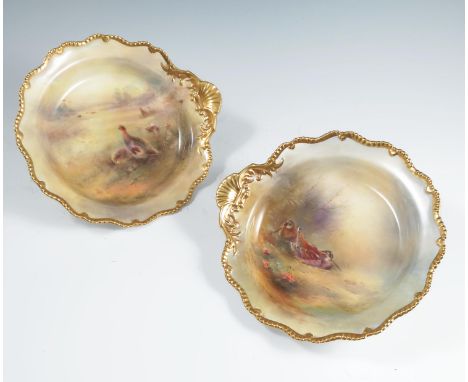 Two Royal Worcester circular shallow bowls, with gilt side handle, decorated with Snipe and Grouse in landscape, both by Jas 