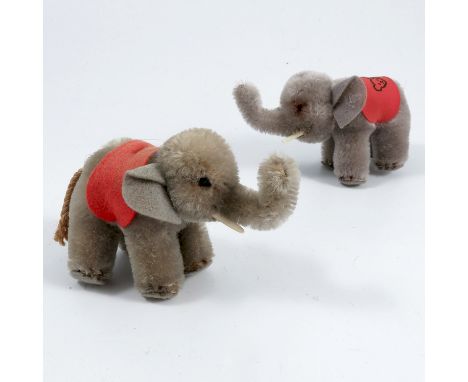 Two Steiff elephants, with red cloths on their backs