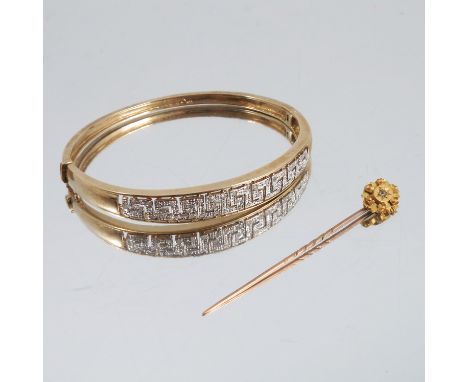 A 9 carat gold diamond hinged bangle, the Greek key frontispiece set with single cuts, internal diameter 6.1cm, 15g gross, ca