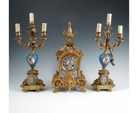 A 19th century gilt metal and porcelain clock garniture, the striking movement with stamp for Japy Freres, numbered 666, the 