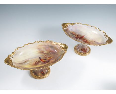 Two Royal Worcester oval comports, decorated with Grouse and Pheasants in landscape, both by Jas Stinton, with gilt shaped ed