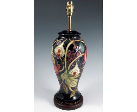 A Moorcroft Pottery lamp base, decorated in the Fig and Peach pattern to a dark blue ground,height 18.5insCondition Report:  