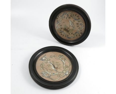 A pair of 19th century circular tapestry pictures, of a bird and foliage and scroll frame, diameter 7ins