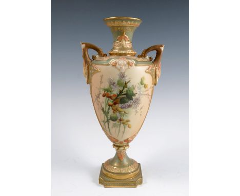 A Royal Worcester blush ivory vase, the two handled vase decorated with thistles and flowers, on a pedestal with square foot,