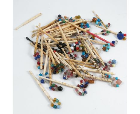 A collection of lace bobbins, to include approximately 54 turned bone examples, most with coloured decoration and some named,