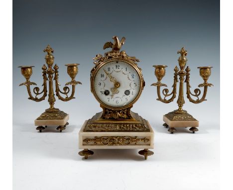 A 19th century clock garniture, the striking drum movement having a white enamel dial with floral garland,&nbsp; in a gilt me