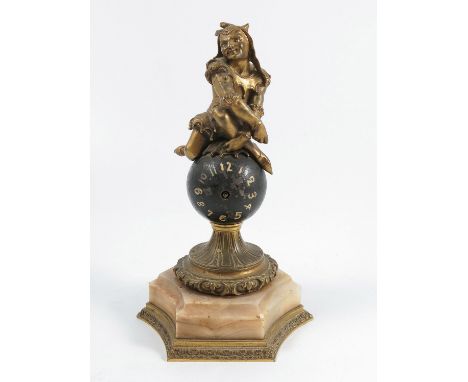 A 19th century mantel clock, the black ball dial containing a pocket watch movement, surmounted by a gilt jester, mounted on 
