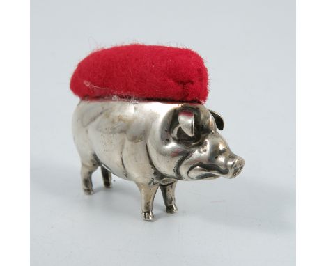 A silver novelty pin cushion, formed as a standing pig, Birmingham assay, marks rubbed
