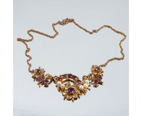 A 9 carat gold amethyst and cultured pearl necklace, circa 1960, with a scrolling foliate frontispiece 48cm long, 17.6g gross