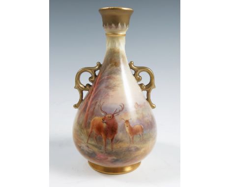 A Royal Worcester vase, decorated with a Stag and deer in landscape to the front by H Stinton, having a pair of gilt scroll h