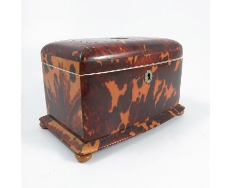 A 19th century tortoiseshell tea caddy, with bow front, the hinged lid opening to reveal two covered compartments, raised on 