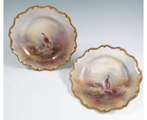 Two Royal Worcester cabinet plates, decorated with ptarmigan in landscape, both by Jas Stinton, with gilt shaped edge, retail