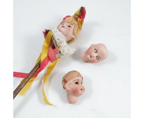 A bisque headed jester, impressed&nbsp;1907 14/0, on a wooden stick with label&nbsp;Au Paradis des Enfants 156 Rue do Rivoli 