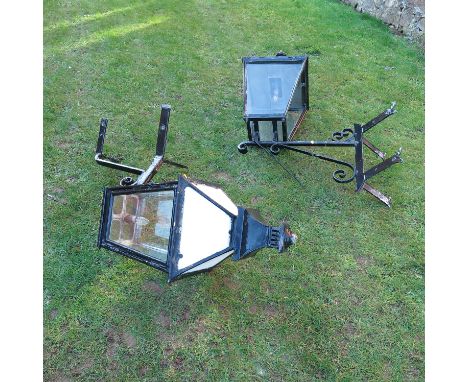 Two similar wrought iron hanging corner lights, having corner brackets, height to include bracket approximately 48ins