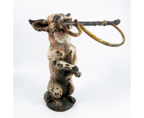A Victorian painted metal stick stand, modelled as a terrier dog begging with a hunting crop in its mouth, height 15insCondit