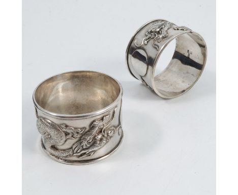 A cased pair of Chinese silver napkin rings, embossed with dragons, maker WA