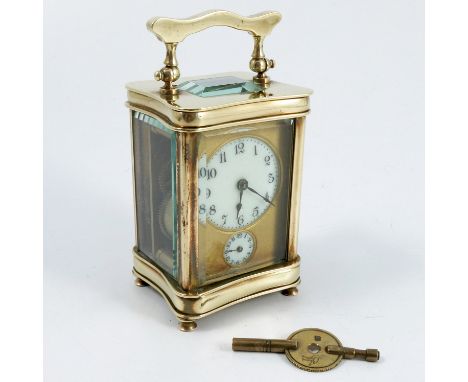 A brass cased alarm carriage clock, with circular white dial and smaller circular hour dial below, with bell to the base, hei