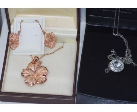Two boxed sets of jewellery silver flowers and swarovski style pendants