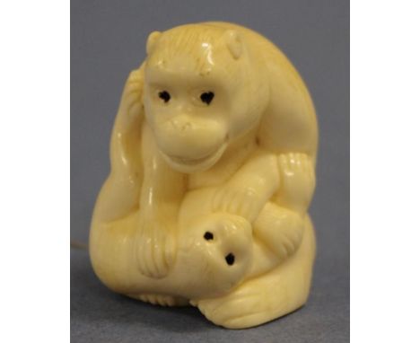 Early ivory netsuke of monkey seated monkey with young, signed to base. Export of this item would require CITES approval. Hei