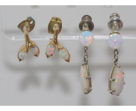 Two pairs of solid opal earrings one set can be worn as studs or with dangling opal, all backs have been replaced