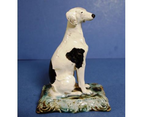 Antique Mintons earthenware greyhound figure applied ceramic mark to base. Height 16cms Length 12cms approx. Provenance: The 