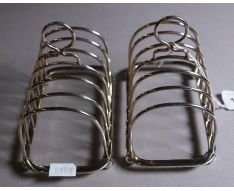 Pair Elizabeth II sterling silver toast racks Sheffield 1977, makers Henry Hutton & Co. Weight 226grams approx.